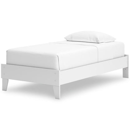 White upholstered platform bed with rounded corners and two pillows on top