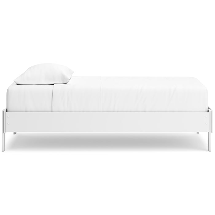 White platform bed side view with slatted frame and two pillows