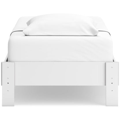 White platform bed with rectangular front panels and two pillows at the head
