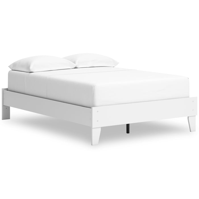 White platform bed angled view with pillows and tapered legs