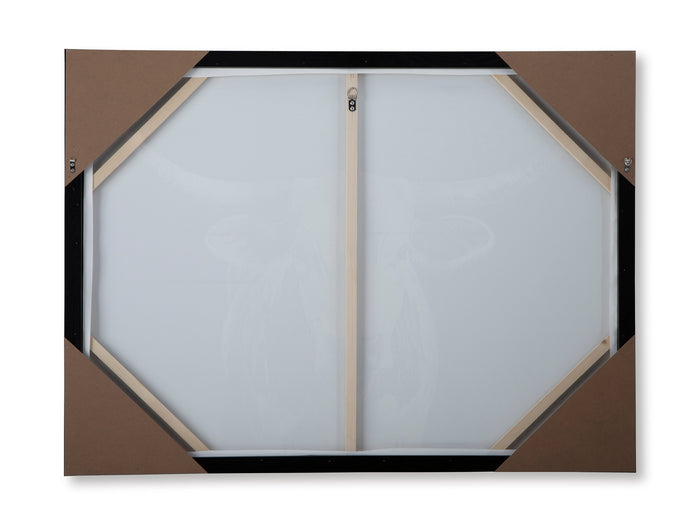 Back of framed wall art with hexagonal backing and hanging brackets.