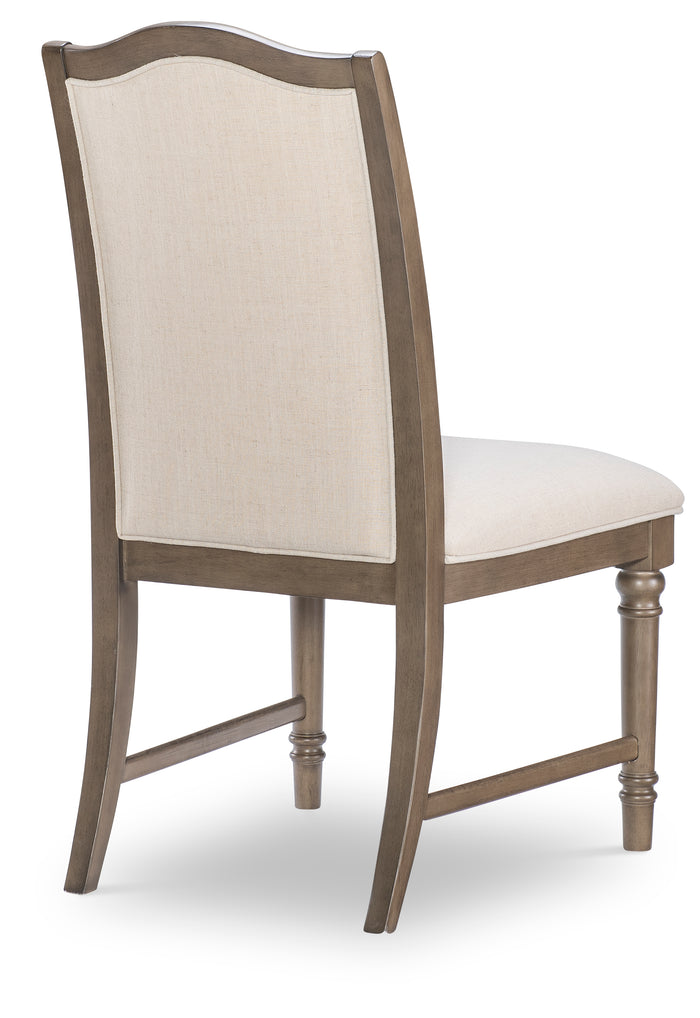 Upholstered dining side chair with beige backrest panel, light seat, wood frame