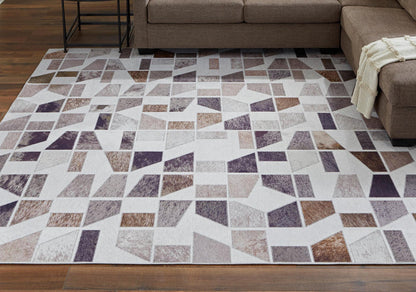 Geometric area rug with white, gray, brown, and dark purple block pattern