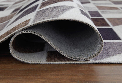 Geometric rug edge close-up with stitched border and dark underside