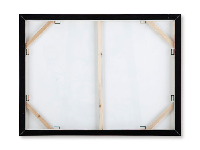 Back view of framed wall art with wooden stretchers and metal corner fasteners