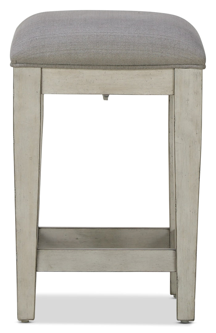 Killian backless stool with gray upholstered seat and light wood frame