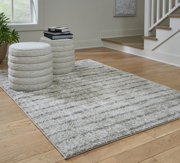 5x7 area rug in living space, gray-and-white textured shag pile