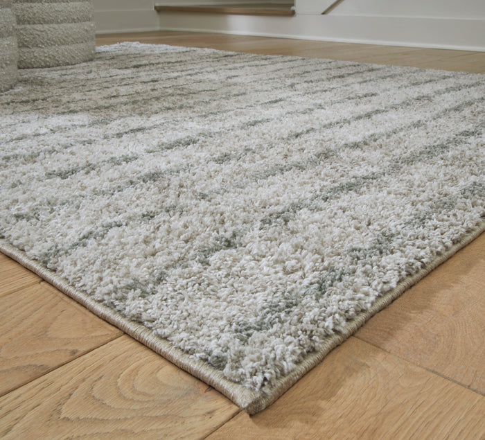 5x7 area rug corner close-up, gray-and-ivory high-pile texture