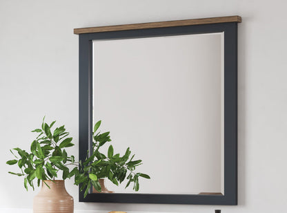 Rectangular bedroom wall mirror with dark frame and wood header trim