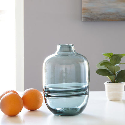 Short light blue glass vase with rounded sides and pedestal base