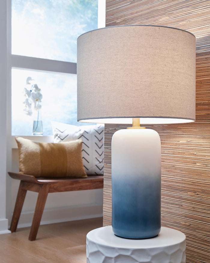 Lemrich table lamp with beige fabric drum shade and blue ceramic base with brass accents
