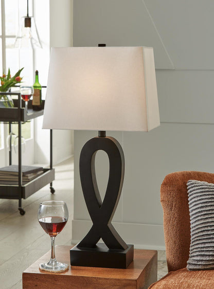 Black table lamp with white square shade and ribbon-shaped base