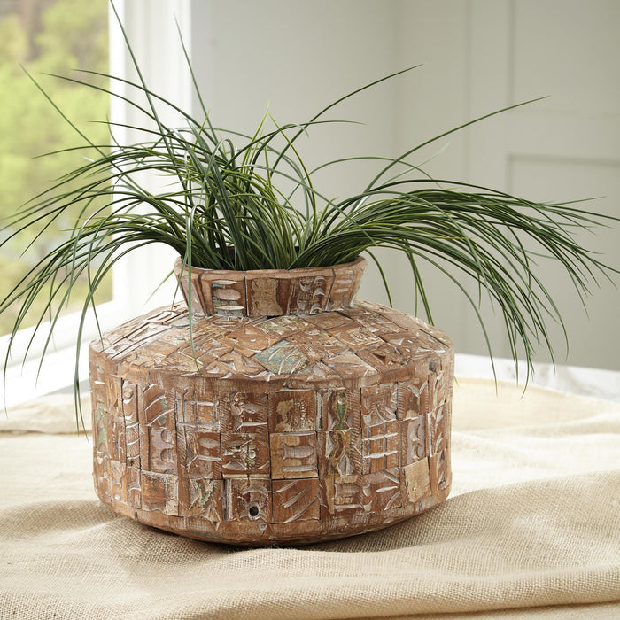 Meltland vase with carved geometric texture and rim opening, holding green grass