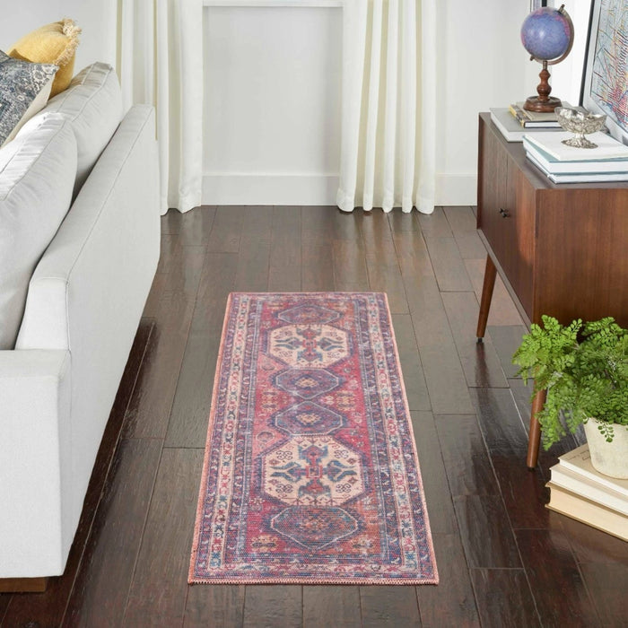 Washable area rug, small rectangular size, with red, blue, and cream medallion design.