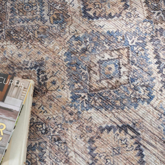 Close-up of blue and beige washable rug texture with diamond motifs and woven detail