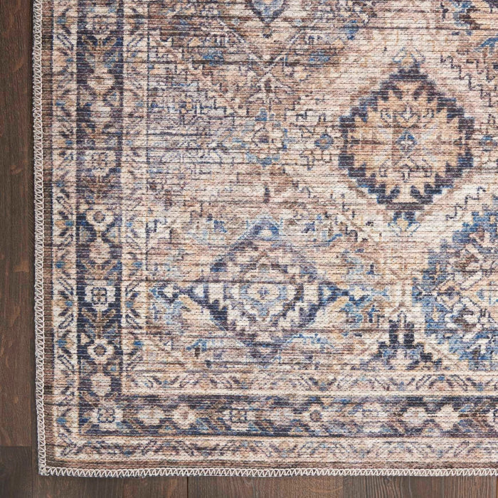 Detailed view of blue and beige washable rug border and diamond pattern