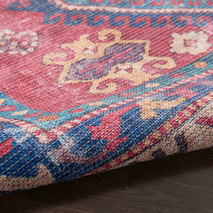 Washable rug weave texture along the border with red, blue, and cream motifs.