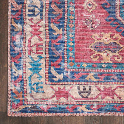 Close-up of washable area rug with red, blue, and beige geometric medallion design