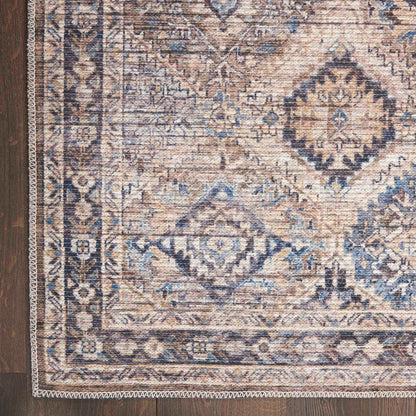 Close-up of beige and blue geometric rug with diamond motifs and patterned border