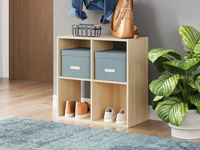 Light tan cube storage organizer with open cubbies, shown with bins and small decor