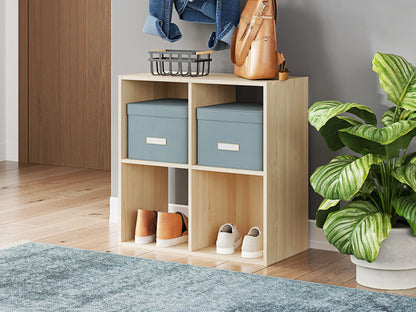 Light tan cube storage organizer with open cubbies, shown with bins and small decor