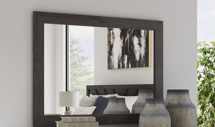 Bedroom mirror in dark wood-look frame, wall-mounted with beveled edge