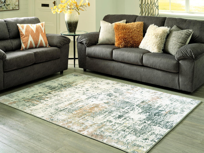 5x7 area rug laid flat, distressed teal and gray abstract design
