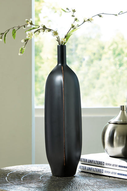 Matte black bottle-shaped vase with copper stripe and small flower stems