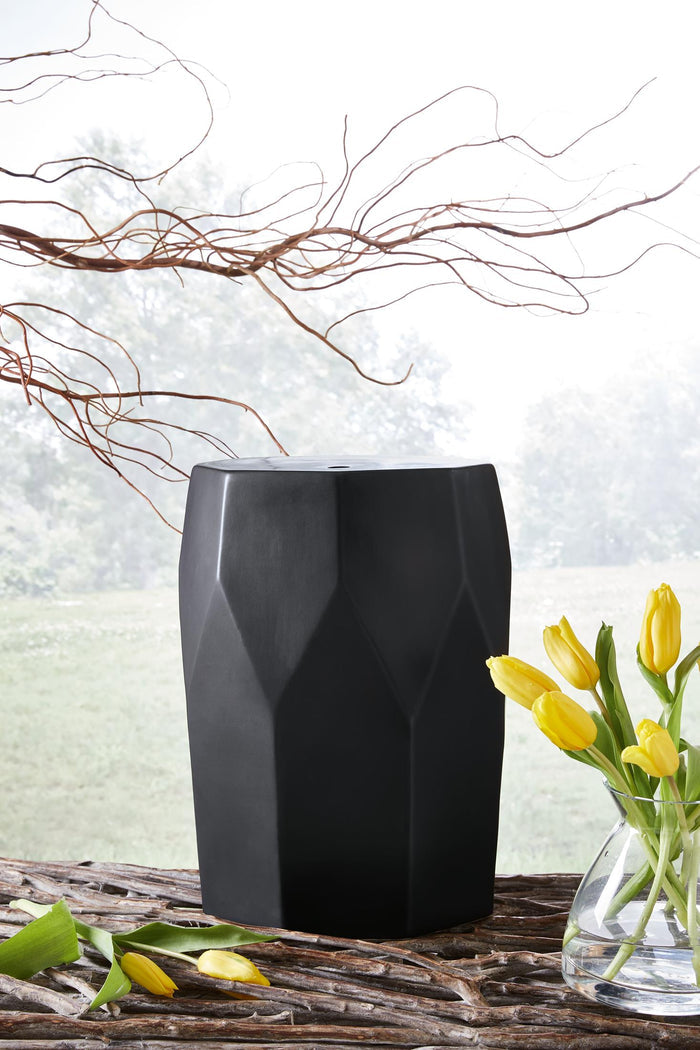 Black geometric faceted stool with flat top, square base