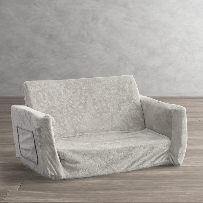 Gray patterned convertible sofa with low base, wide arms, and tuftless cushions