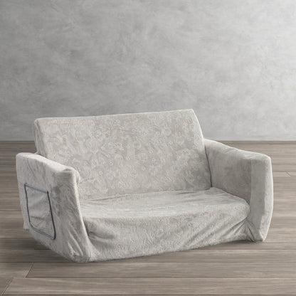 Gray patterned convertible sofa with low base, wide arms, and tuftless cushions