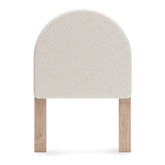 Upholstered headboard front view, rounded light beige upholstered panel and wood posts