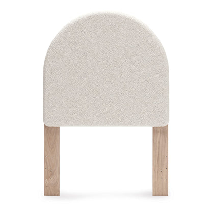 Upholstered headboard front view, rounded light beige upholstered panel and wood posts