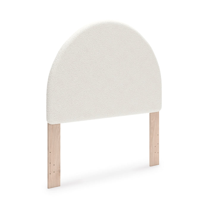 Upholstered headboard with rounded top, light beige upholstery and wooden legs