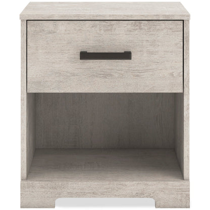 Whitewash nightstand with dark bar drawer pull and open lower shelf.