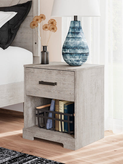 Whitewash nightstand in whitewashed wood with drawer, open shelf, and dark pull.