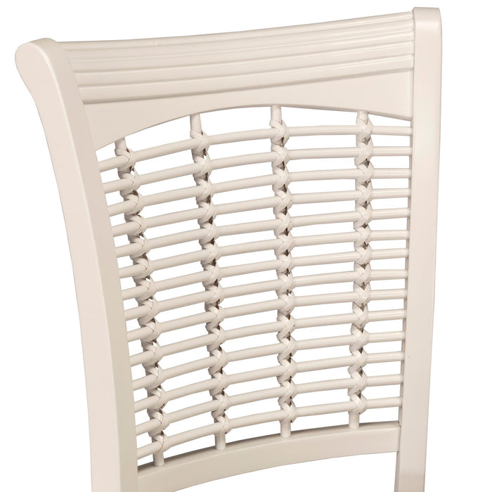 Close-up of a dining chair backrest with a cream-colored wooden frame and woven cane seat slats, shown against a plain white background.
