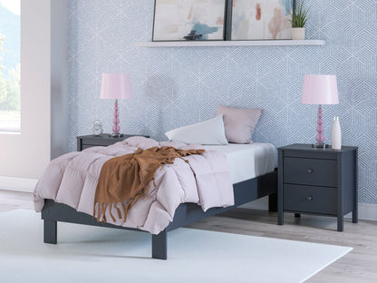 Platform bed with dark blue frame, white upholstered panels, and slatted platform