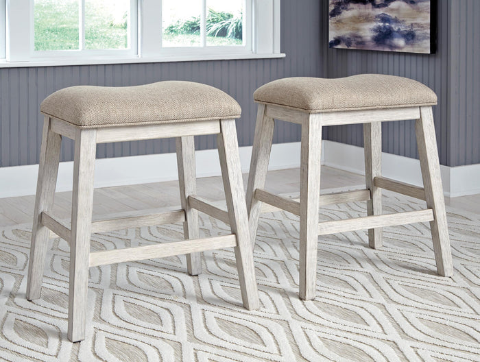Set of 2 counter-height bar stools with beige upholstered seats and light gray frames