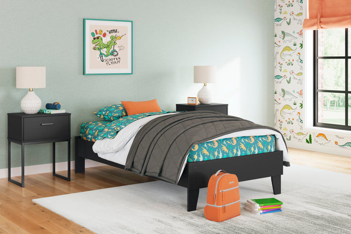 Socalle platform bed with black frame and white mattress, shown in a room setting