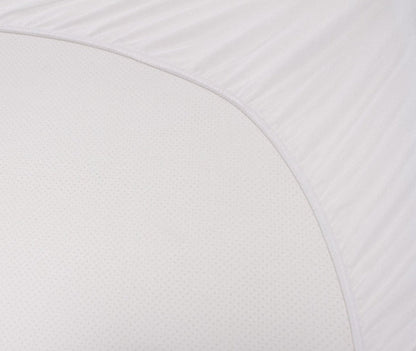 White mattress protector fabric close-up showing textured dotted surface