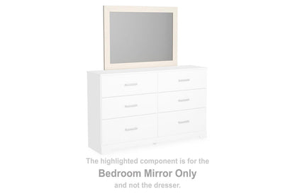 White bedroom mirror on top of a matching dresser with six drawers