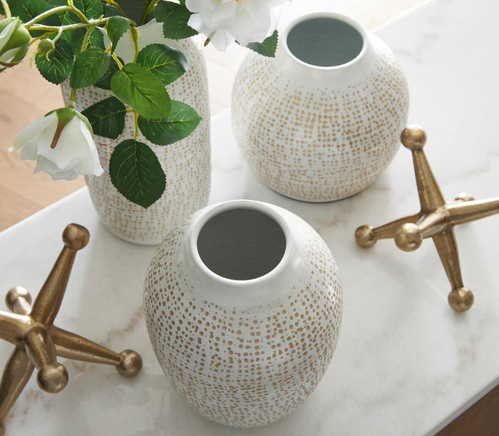 Speckled ceramic vases with bronze starburst accents and white blooms