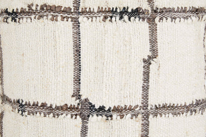 Close-up of plaid pillow fabric with textured weave and dark stitched grid