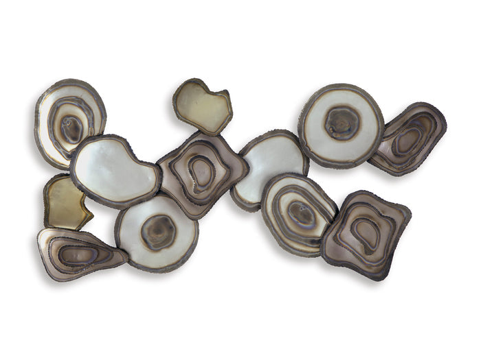 Wall decor of layered oval and circle pieces with dark brown and cream highlights