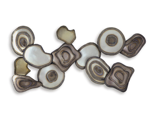 Wall decor of layered oval and circle pieces with dark brown and cream highlights