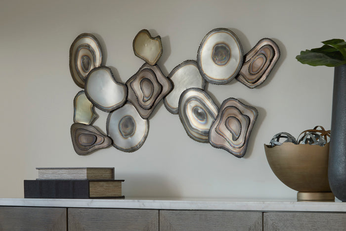 Abstract metal wall decor with layered oval and circular shapes in neutral tones