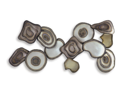 Wall decor metal pieces layered into an abstract fan shape with neutral swirling rings