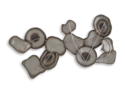 Abstract wall decor cluster of layered metal ovals with swirling ring patterns