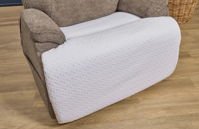 Recliner chair protector close-up with white textured cover over seat and arm area